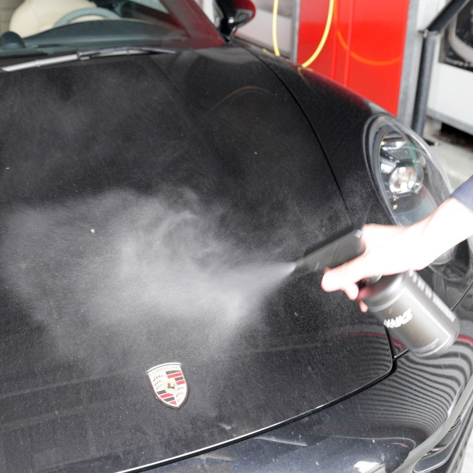 KULT Insektenentferner wird auf die schwarze Fronthaube eines Porsche 911 gesprüht